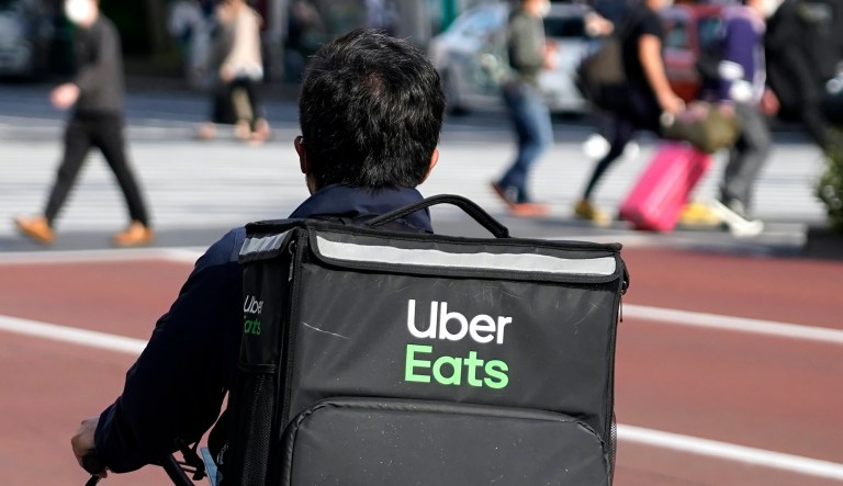 In this Wednesday, Nov. 6, 2019 photo, a restaurant advertises Uber Eats in the Coconut Grove neighborhood in Miami. 