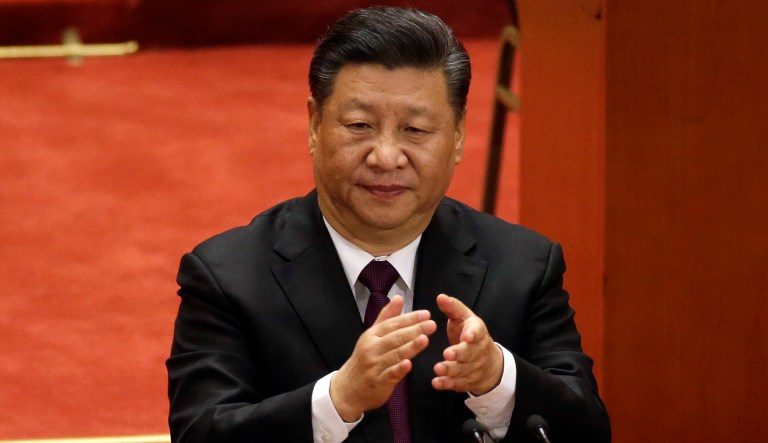 Chinese President Xi Jinping applauds during a conference to commemorate the 40th anniversary of China's Reform and Opening Up policy at the Great Hall of the People in Beijing, Tuesday, Dec. 18, 2018.