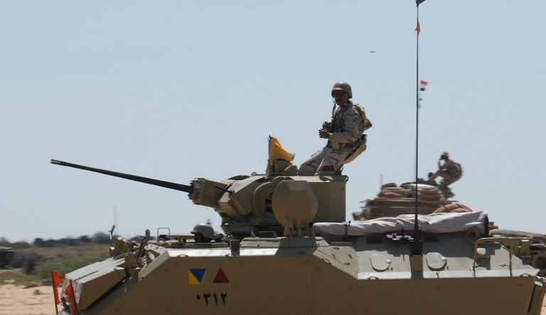 Egyptian armored vehicles stand alert near the Rafah border crossing between Egypt and the Gaza Strip.