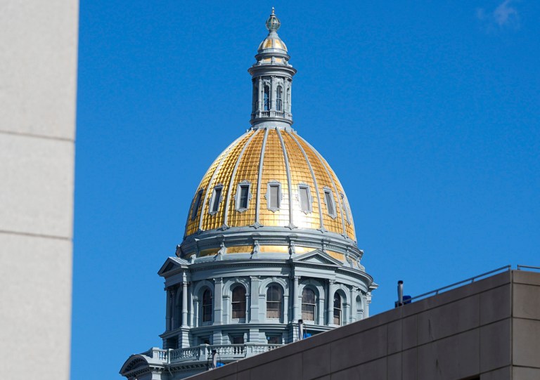 The gold dome of the State Capitol is shown on Wednesday, Feb. 14, 2024, in downtown Denver. A report published this week, Friday, June 14, by a Native American-led nonprofit examines in detail the dispossession of $1.7 trillion worth of Indigenous homelands in Colorado by the state and the U.S. and the more than $546 million the state has reaped in mineral extraction from them. (AP Photo/David Zalubowski, File)