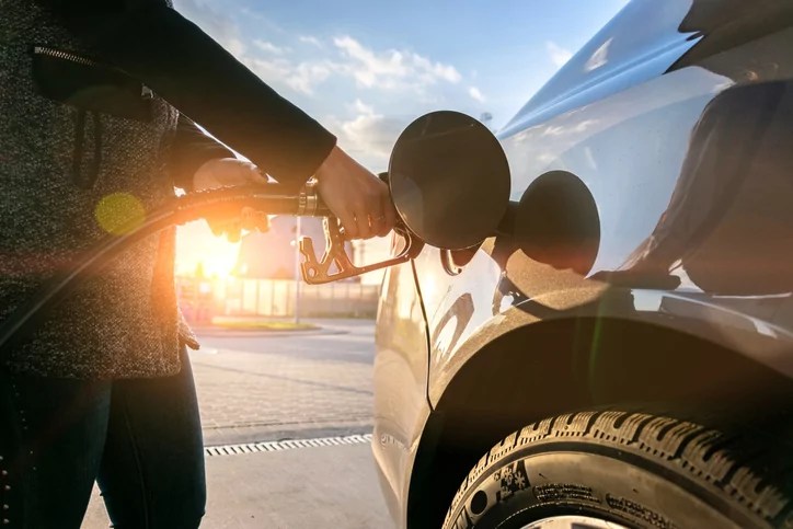 Refueling car. Pump gas at petrol fuel station. Gasoline oil nozzle tank from hand person. Automotive industry or transportation concept.