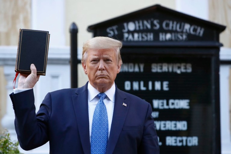 President Donald Trump holds a Bible as he visits outside St. John's Church, June 1, 2020, in Washington.
