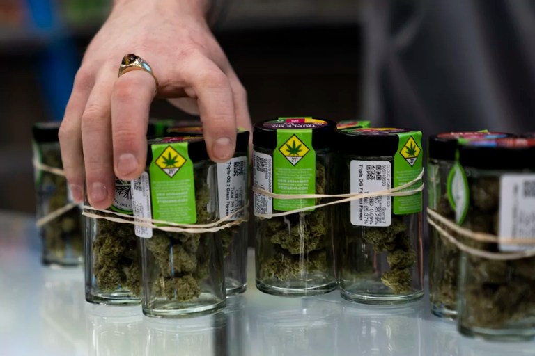 An employee puts away product at Cloud 9 Cannabis.