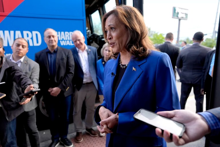 Democratic presidential nominee Vice President Kamala Harris speaks to reporters as second gentleman Doug Emhoff, from third right, Democratic vice presidential nominee Minnesota Gov. Tim Walz and his wife Gwen Walz, listen outside a Primanti Bros. restaurant during a campaign stop, Sunday, Aug. 18, 2024, in Pittsburgh. (AP Photo/Julia Nikhinson)