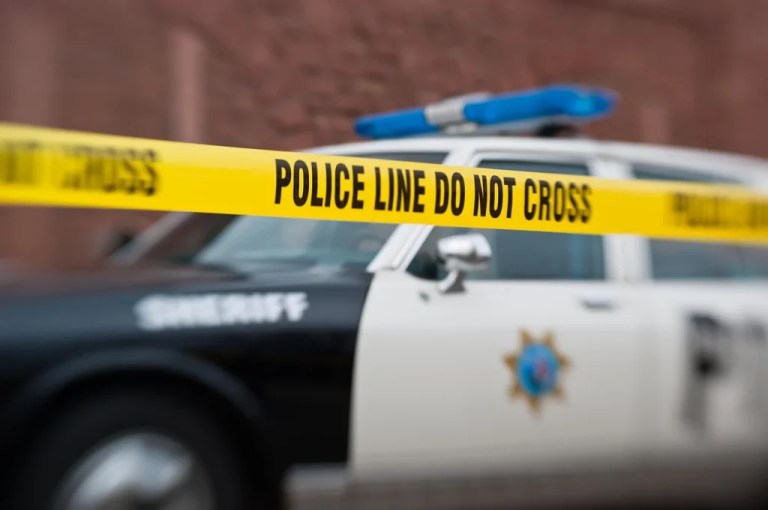 Sheriff's police car with yellow barrier tape