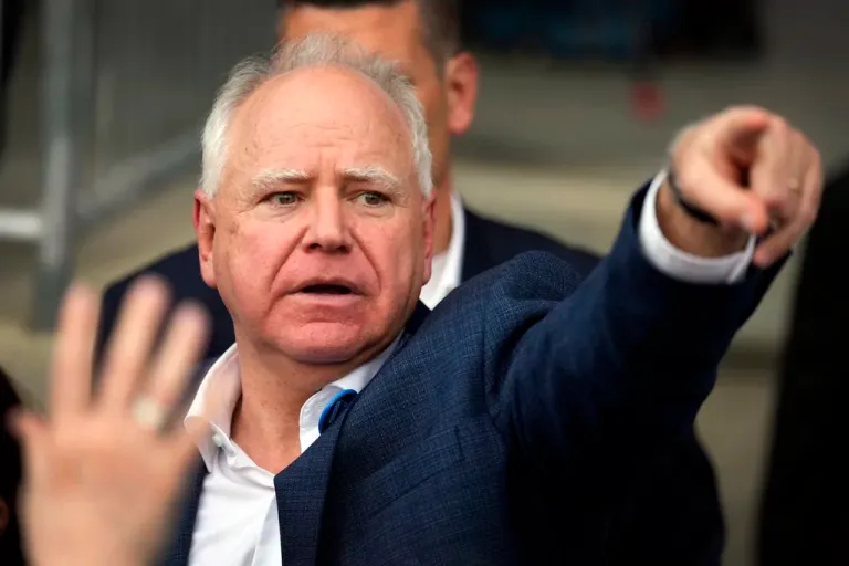 Gov. Tim Walz (D-MN), Democratic vice presidential nominee, greets supporters during a campaign rally, Saturday, Oct. 19, 2024, in Papillion, Nebraska. (AP Photo/Charlie Neibergall)