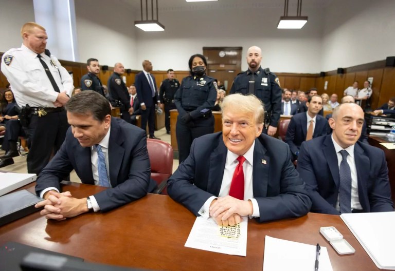 Flanked by his attorneys, Todd Blanche and Emil Bove, former President Donald Trump awaits the start of proceedings in a Manhattan criminal court.