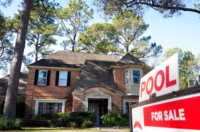 In this Wednesday, Jan. 13, 2021, file photo, a real estate sign is shown at a home for sale, in Houston. The red-hot U.S. housing market is paying off for many homeowners, even those who aren’t looking to sell their home. Real estate information company CoreLogic says, on average, homes with a mortgage gained $26,300 in equity over the last three months of 2020 versus a year earlier.