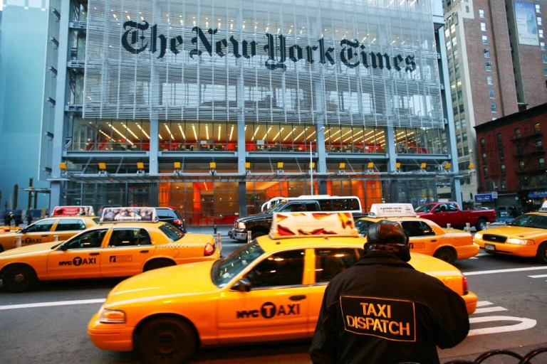 Taxis pass The New York Times building in this March 18, 2008, file photo. The New York Times lost $335,000 in the first quarter as advertising revenues slumped, the newspaper publisher said Thursday, April 17, 2008, in a report that fell far short of Wall Street estimates. (AP Photo/Mark Lennihan, file)
