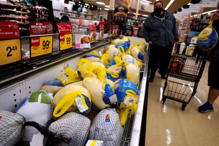 People shop for frozen turkeys.