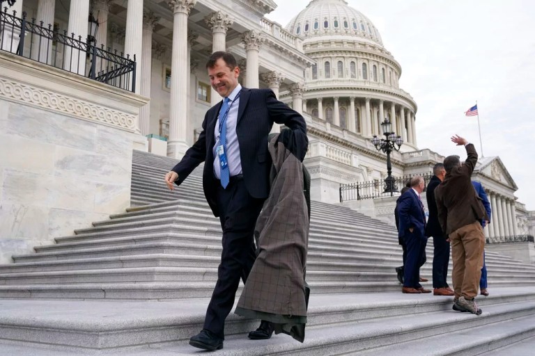 Rep. Tom Kean (R-NJ) removes his coat as he arrives for a class photo of newly elected members of Congress on the east front of the Capitol in Washington, Tuesday, Nov. 15, 2022.