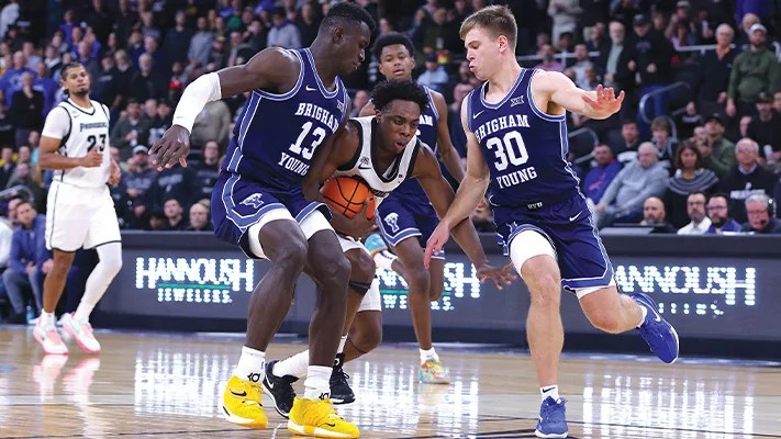 Providence Friars’ Jayden Pierre (1) is double-teamed by BYU Cougars’ Dallin Hall (30) and Keba Keita (13).
