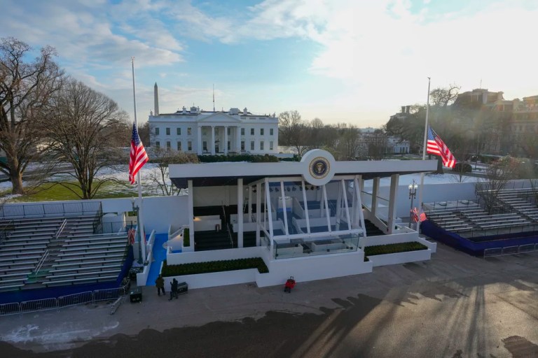 Workers continue with the finishing touches on the presidential reviewing stand on Pennsylvania outside the White House Thursday, Jan. 16, 2025, in Washington, ahead of President-elect Donald Trump's inauguration. (Jon Elswick via AP)