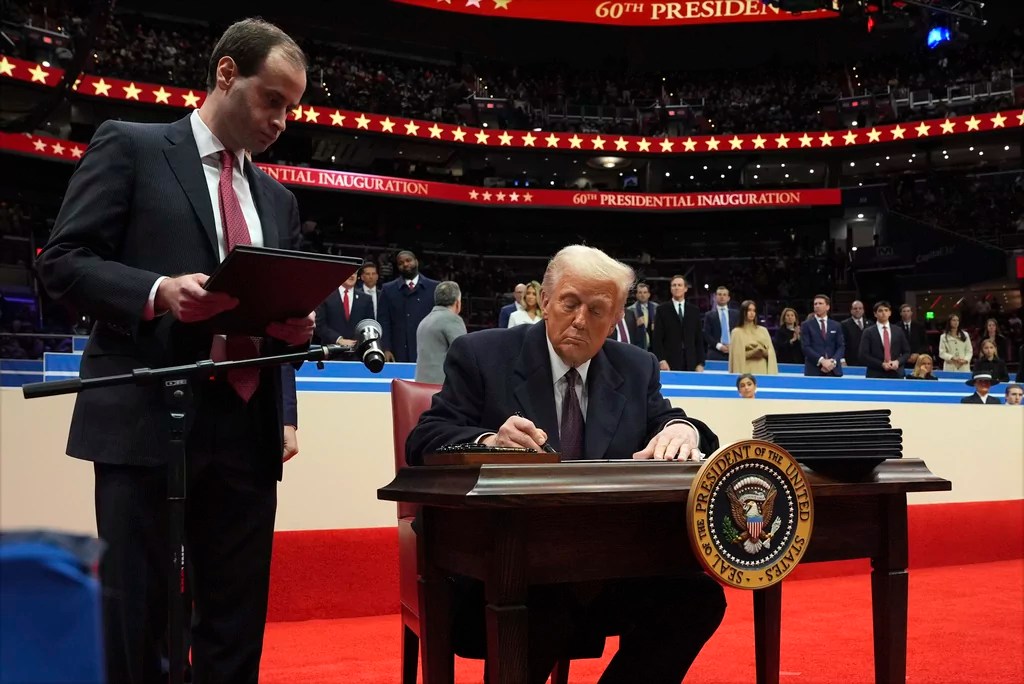 Trump signs first nine executive orders and other documents of presidency in front of cheering crowd