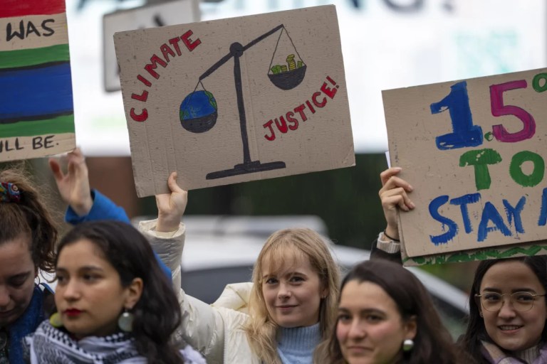 Activists protest outside the International Court of Justice, in The Hague, Netherlands, as it opens hearings into what countries worldwide are legally required to do to combat climate change and help vulnerable nations fight its devastating impact, Monday, Dec. 2, 2024.