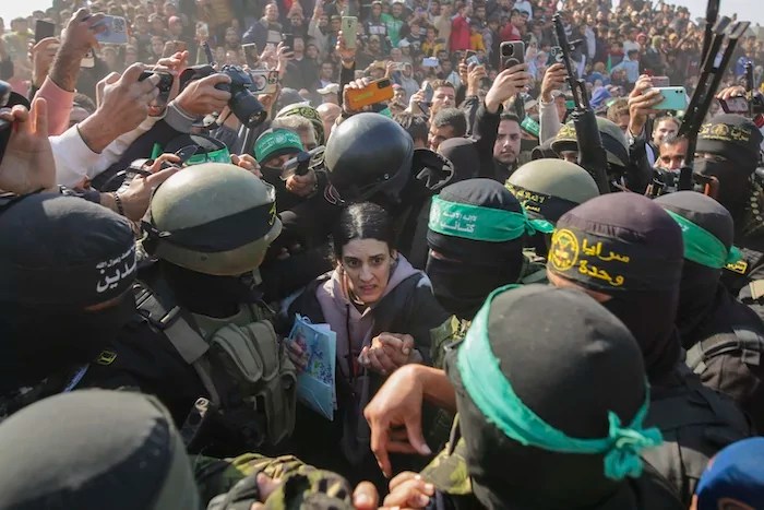 Israeli captive Arbel Yehoud, 29, who has been held hostage by Hamas in Gaza since October 7, 2023, is escorted by Hamas and Islamic Jihad fighters as she is handed over to the Red Cross in Khan Younis, southern Gaza Strip, Thursday Jan. 30, 2025.(AP Photo/Jehad Alshrafi)