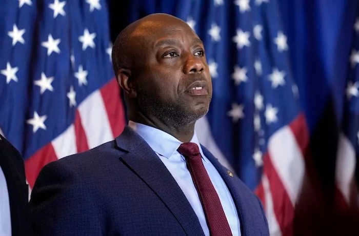 Sen. Tim Scott, R-S.C., listens as Republican presidential candidate former President Donald Trump speaks at a primary election night party in Nashua, N.H., Tuesday, Jan. 23, 2024. (AP Photo/Matt Rourke)