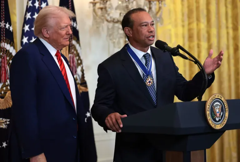 Gold legend Tiger Woods speaks, right, alongside President Donald Trump during a reception honoring Black History Month in the East Room of the White House on Feb. 20, 2025, in D.C.