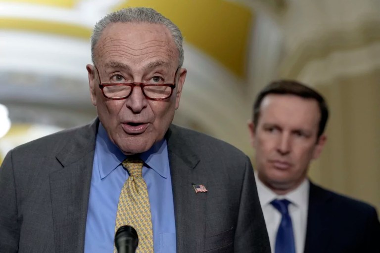 Senate Majority Leader Chuck Schumer (D-NY), left, talks as Sen. Chris Murphy (D-CT), right, listens during a news conference