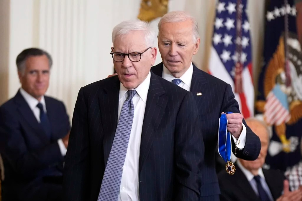 President Joe Biden, right, presents the Presidential Medal of Freedom, the Nation's highest civilian honor, to David Rubenstein in the East Room of the White House, Saturday, Jan. 4, 2025, in Washington. (AP Photo/Manuel Balce Ceneta)