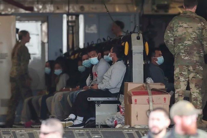 Migrants sit on a military aircraft at Fort Bliss in El Paso, Texas on Thursday, Jan. 30, 2025, awaiting their deportation to Guatemala.