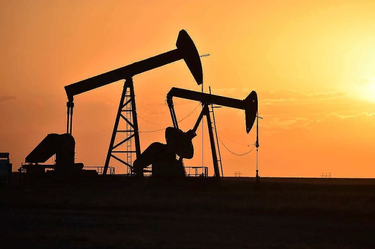 Pump jacks extract oil from beneath the ground in North Dakota, May 19, 2021.