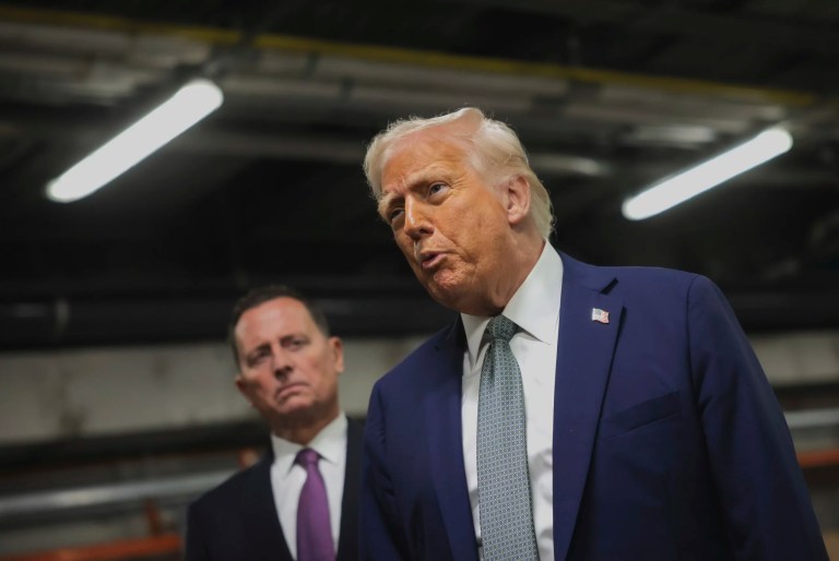 President Donald Trump talks to reporters as Richard Grenell, president of the Kennedy Center Board of Trustees, listens as he visits the John F. Kennedy Center for the Performing Arts in Washington, Monday, March 17, 2025.