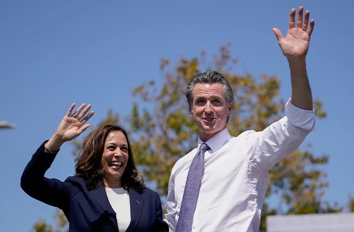 Vice President Kamala Harris stands on stage with Gov. Gavin Newsom (D-CA).