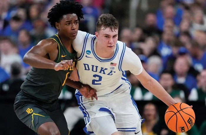 Duke forward Cooper Flagg drives past Baylor guard Robert Wright III.
