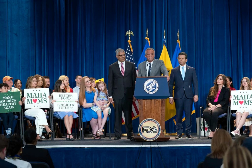 Health and Human Services Secretary Robert F. Kennedy Jr. flanked by Director of the National Institutes of Health Jay Bhattacharya, left, and Food and Drug Administration (FDA) commissioner Marty Makary, right, speaks during a news conference on the FDA's intent to phase out the use of petroleum-based synthetic dyes in the nation's food supply at the Hubert Humphrey Building Auditorium in Washington, Tuesday, April 22, 2025.
