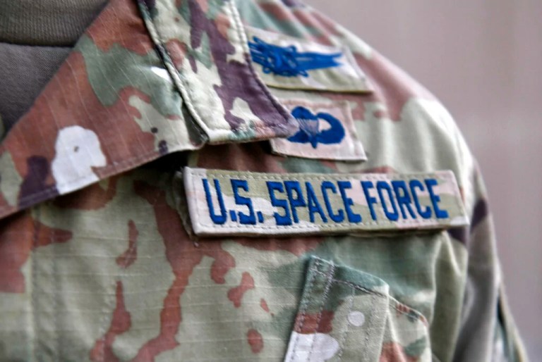 In this photo released by the U.S. Air Force, Capt. Ryan Vickers stands for a photo to display his new service tapes after taking his oath of office to transfer from the U.S. Air Force to the U.S. Space Force at Al-Udeid Air Base, Qatar, Tuesday, Sept. 1, 2020.