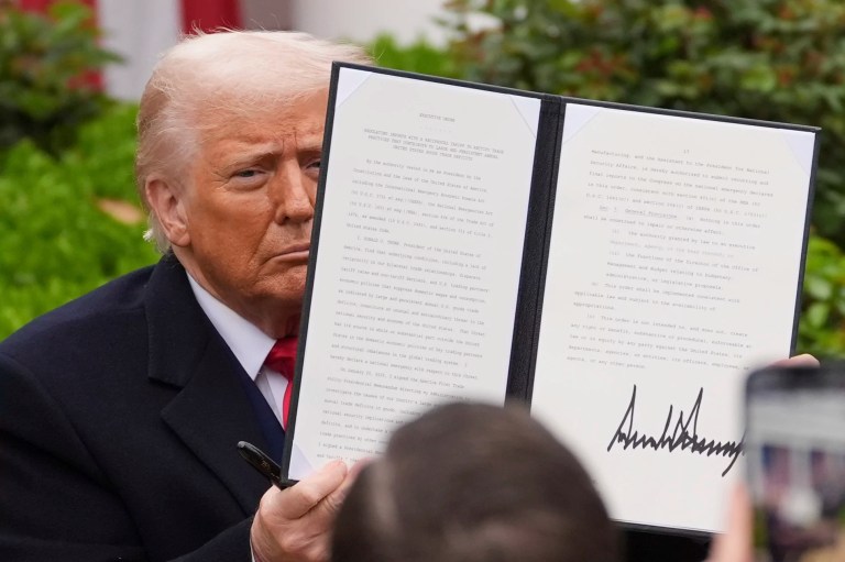 President Donald Trump holds a signed executive order during an event to announce new tariffs in the Rose Garden of the White House, Wednesday, April 2, 2025, in Washington.