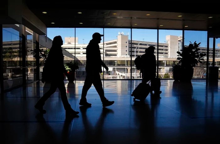Travelers walk through Philadelphia International Airport in Philadelphia, Friday, Feb. 16, 2024. On Friday, March 15, 2024, the University of Michigan releases its preliminary reading of consumer sentiment for April.