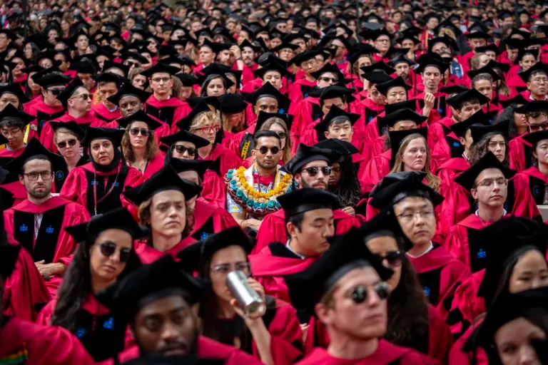 Students listen during commencement in Harvard Yard