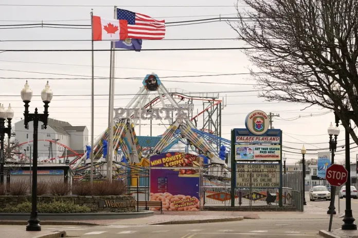 American and Canadian flags fly near the Palace Playland amusement park on April 2, 2025, in Old Orchard Beach, Maine, a summer seaside resort town popular with French-Canadian tourists. (AP Photo/Robert F. Bukaty)