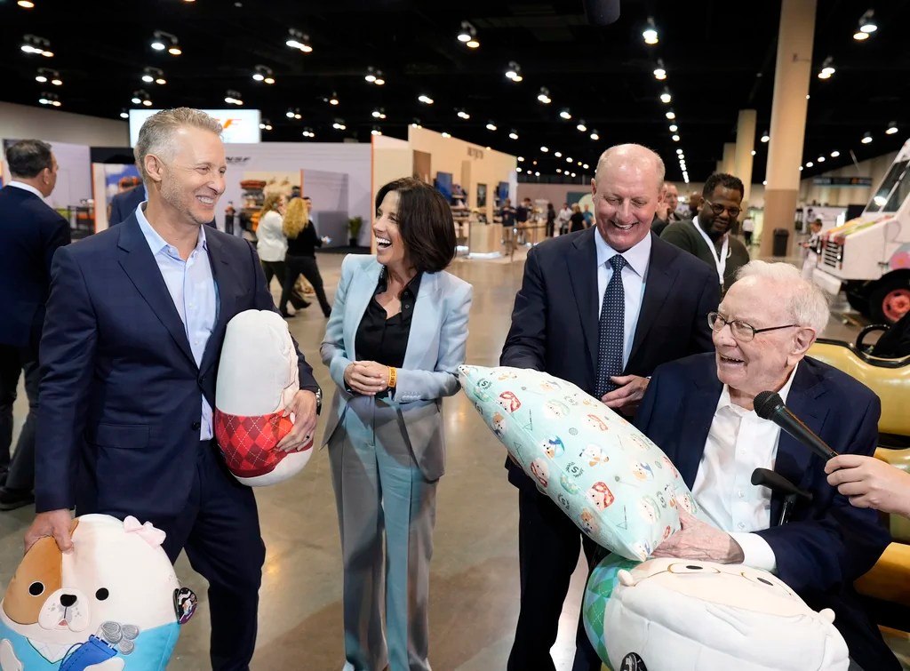 Jazwares CEO Judd Zebersky and president Laura Zebersky greets Greg Abel, Berkshire Hathaway Vice Chairman and Warren Buffett, Chairman and CEO of Berkshire Hathaway with the Squish Pillow that was revealed at the 2025 Berkshire Hathaway Annual Shareholders Festival at the CHI Health Center on Friday, May 2, 2025 in Omaha, Neb. 