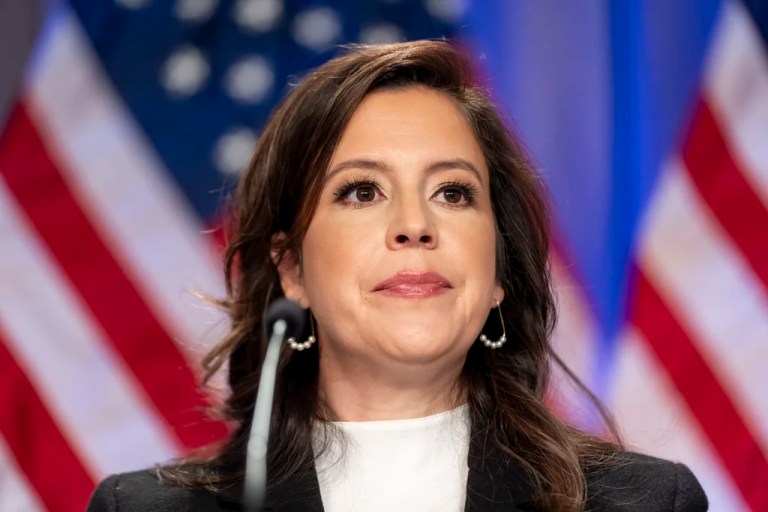 Elise Stefanik is seated before President-elect Donald Trump.
