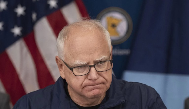 Tim Walz behind a podium