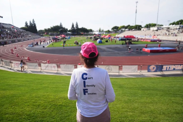Mary Davis wears a T-shirt opposing transgender participation in girls' sports during the California high school track-and-field championships in Clovis, Calif., Saturday, May 31, 2025. (AP Photo/Jae C. Hong)
