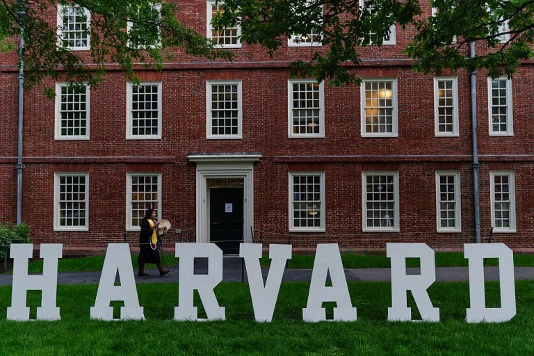 A students walks past a display on the Harvard University campus.