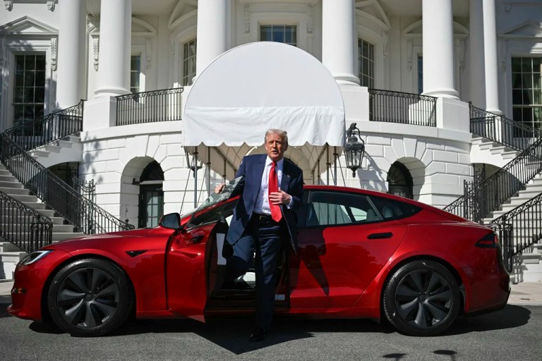 President Donald Trump steps out of a red Model S Tesla vehicle on the South Lawn of the White House on Tuesday, March 11, 2025, in Washington.