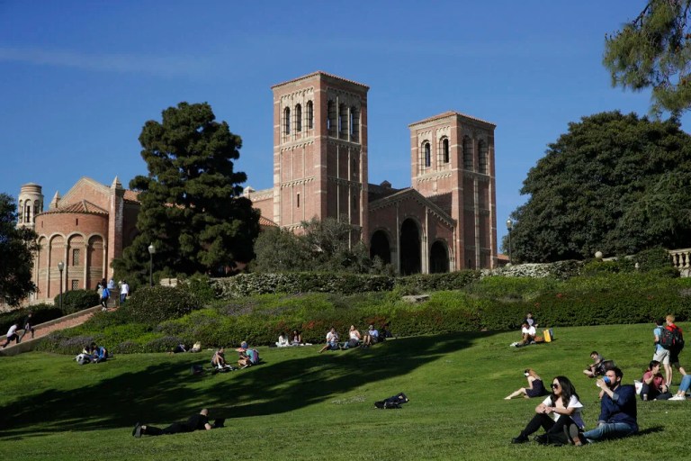 Students sit on the lawn near Royce Hall at the University of California, Los Angeles, in the Westwood section of Los Angeles on April 25, 2019.