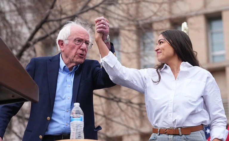 Sen. Bernie Sanders greets Rep. Alexandria Ocasio-Cortez.