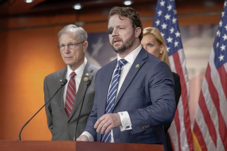 Rep. Dan Crenshaw, R-Texas, speaks during a news conference on border security, Wednesday, Feb. 14, 2024, on Capitol Hill, in Washington. (AP Photo/Mariam Zuhaib)