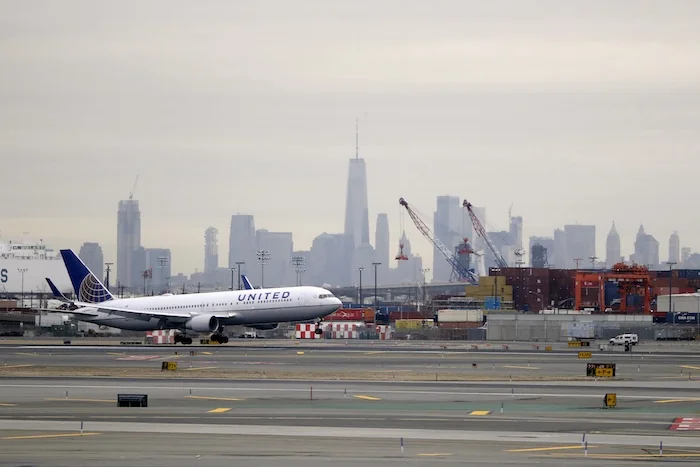 A United Airlines jet touches down at Newark Liberty International Airport.