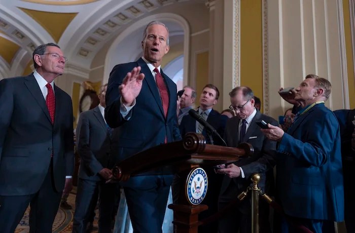 Senate Majority Leader John Thune, R-S.D., center, joined at left by Sen. John Barrasso, R-Wyo., the GOP whip, speaks to reporters after Republican senators met with Treasury Secretary Scott Bessent and worked on President Donald Trump's tax and immigration megabill