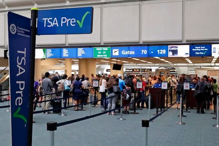 FILE- In this Thursday, June 21, 2018 photo, air passengers heading to their departure gates enter TSA pre-check before going through security screening at Orlando International Airport, in Orlando, Fla. Investigators were unable to corroborate specific allegations that a Transportation Security Administration supervisor instructed air marshals to racially discriminate against passengers at Florida's busiest airport. But investigators for the Department of Homeland Security's Office of Inspector General uncovered other concerns about racial profiling of passengers by other TSA supervisors at Orlando International Airport, according to a report sent to lawmakers last week. (AP Photo/John Raoux)