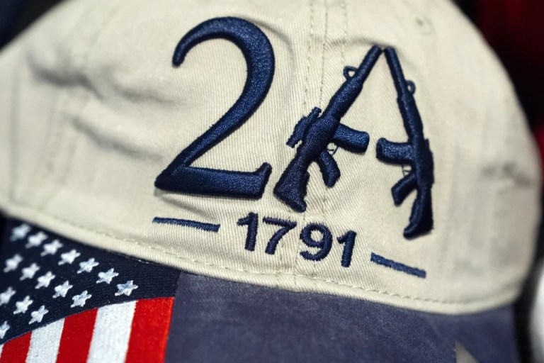 A hat with embroidered assault rifles in support of the second amendment