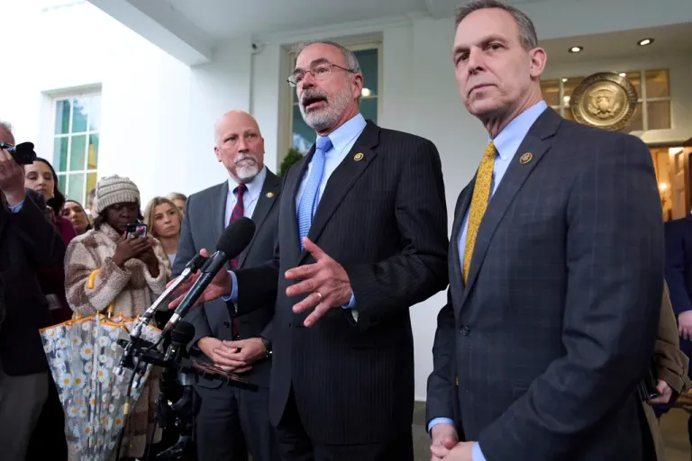 Rep. Chip Roy (R-TX), left, and Rep. Scott Perry (R-PA), right, listen as House Freedom Caucus Chairman Andy Harris (R-MD) speaks to reporters