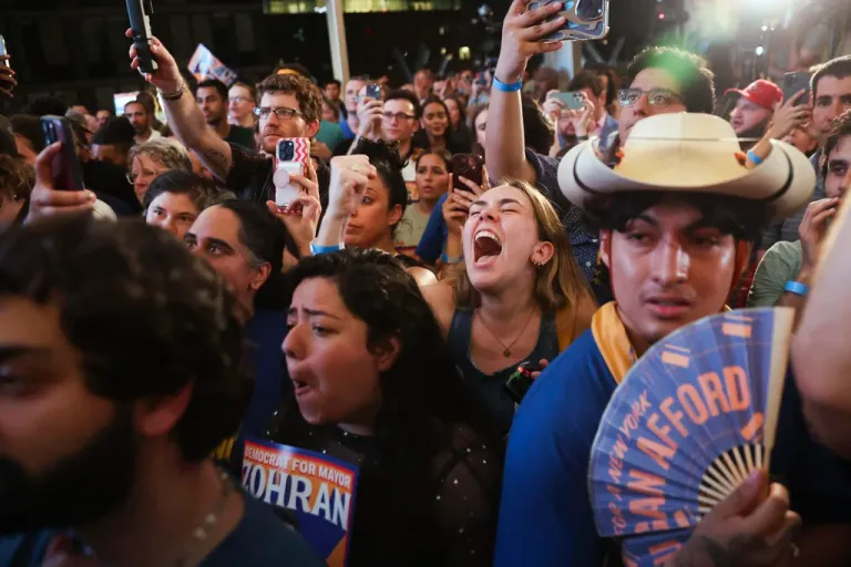 Supporters of Democratic mayoral candidate Zohran Mamdani cheer